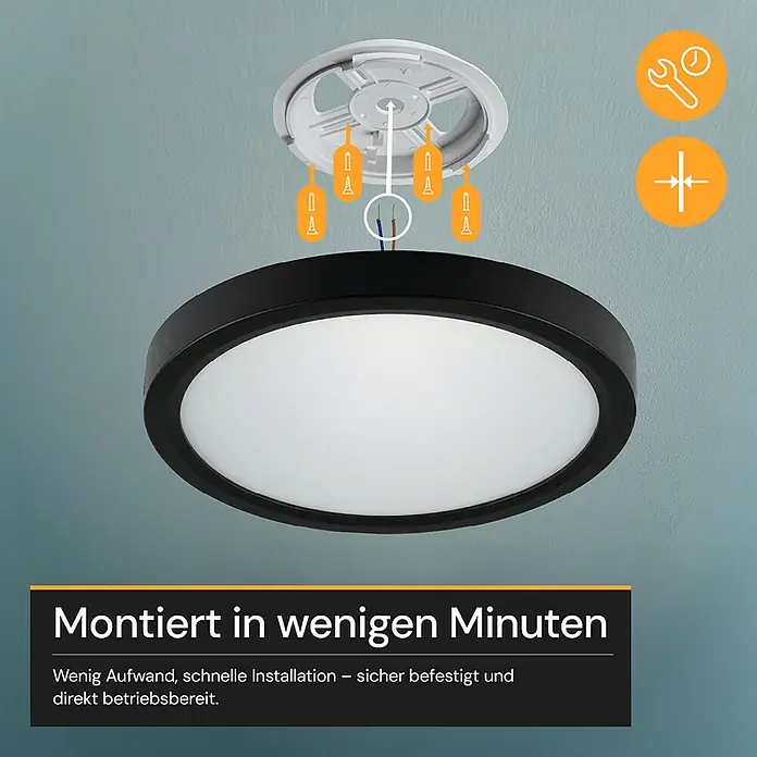 Enovalite LED-Deckenleuchte rund - 22 W, Ø x H: 30 cm x 35 mm, Schwarz, Warmweiß - Rundes schwarzes Deckenlicht mit weißem Diffusor, Montage auf blauer Decke mit Halterung und Schrauben. Zeigt einfache Installation.