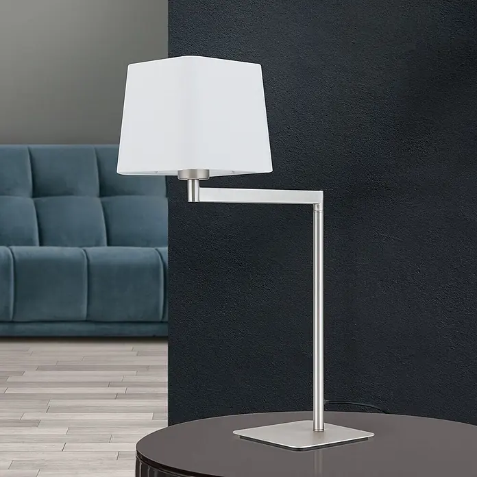 Orion Leuchten Tischleuchte - 40 W, L x B x H: 37,5 x 16 x 53 cm, E27 - Moderne Tischlampe mit weißem quadratischem Stoffschirm und gebürstetem Metallarm und -fuß, auf einem dunklen Tisch.