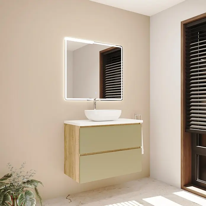 Mueble bajo de lavabo Isa - An x Pr x Al: 90 x 44,6 x 54,5 cm, Verde, Apertura con uñero ingletado 45 grados - Mueble de baño moderno con marco de madera clara, cajones verde salvia, encimera blanca, lavabo sobre encimera blanco y espejo rectangular iluminado.