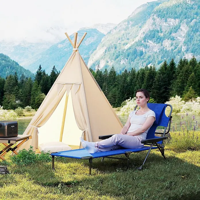 Furnicato Gartenliege - B x T: 72 x 194 cm, Dunkelblau, Polyester - Eine Frau entspannt sich im Freien auf einem blauen Campingliegestuhl mit Rückenlehne, neben einem Zelt.