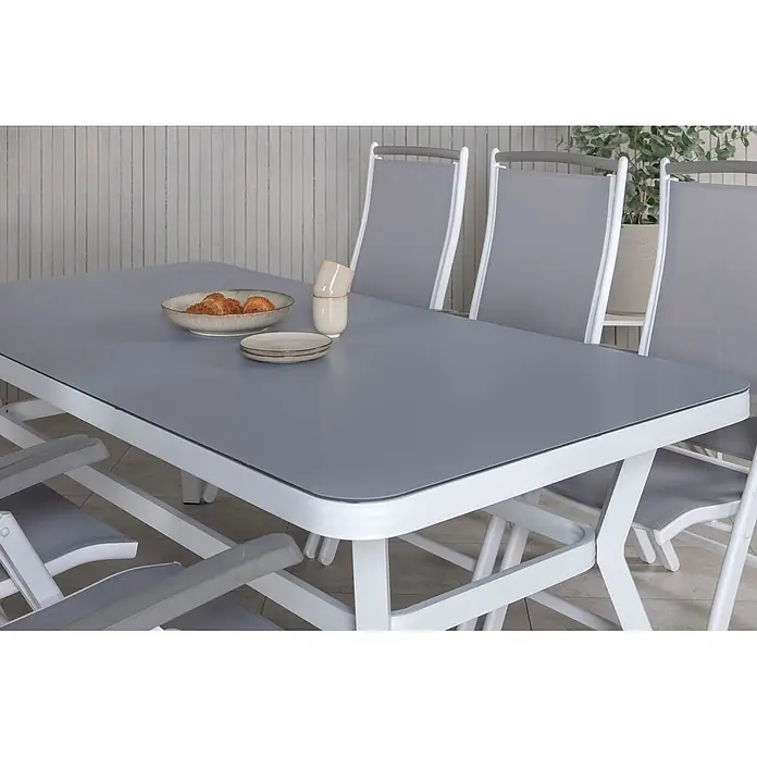 Ebuy24 Gartentisch Massa - L x B x H: 200 x 100 x 74 cm, Ø x H: 100 x 74 cm, Aluminium, Glas, Schnur, Sonstige, Weiß - Gartensitzgruppe mit grauem Tisch und weißgerahmten Stühlen mit grauem Stoff, auf einer Terrasse.