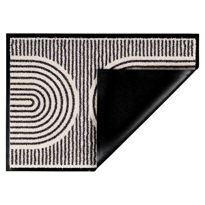 Fußmatte Bellevue - 100 x 67 cm, Creme, Material Nutzschicht: 100 % Polyamid, Semi-Circles - Rechteckiger schwarz-weißer Teppich mit geometrischen Streifen und Kurven; eine Ecke ist umgeklappt und zeigt die schwarze rutschfeste Unterseite.