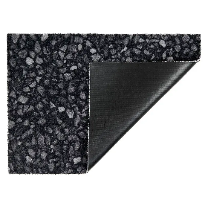 Fußmatte Orlando - 70 x 50 cm, Schwarz, Material Nutzschicht: 100 % Polyamid, Terrazzo - Dunkelgrauer gesprenkelter Teppich, dessen Ecke angehoben ist und die schwarze, texturierte rutschfeste Rückseite zeigt.