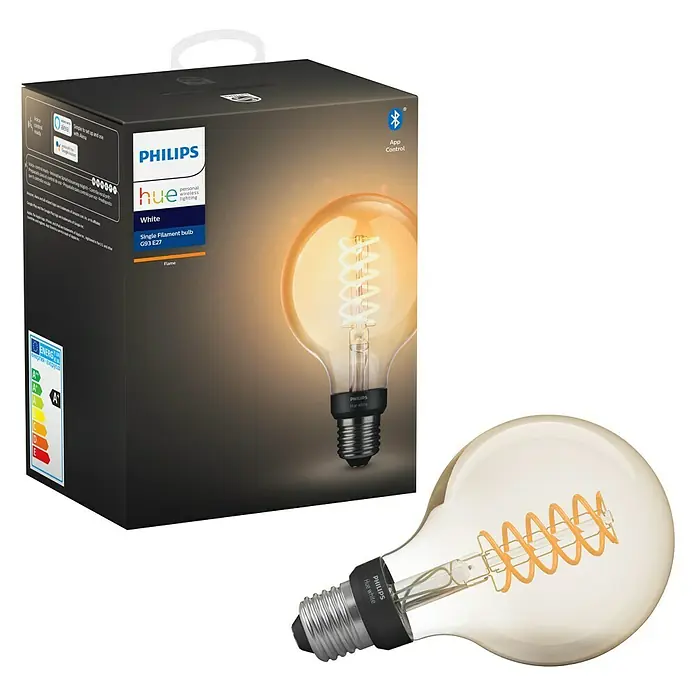 Philips Hue Bombilla LED inteligente Filamento blanco - E27, Intensidad regulable, Blanco cálido, 550 lm, 7 W, Denominación de la lámpara: G93 - La imagen muestra una bombilla de filamento Philips Hue White G93 E27 junto con su embalaje, destacando sus características y beneficios.