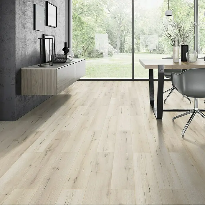 Classen Vinylbodenmuster GreenVinyl Sand-Eiche - 300 x 173 x 3,8 mm, Landhausdiele - Innenaufnahme mit hellen Holzdielen, einem Tisch mit Stühlen, einer Anrichte und einer grauen Wand. Das Licht durchflutet den Raum.