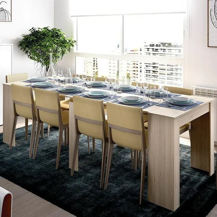 Dekit Mesa de comedor Kiona - L x An x Al: 90 x 239 x 77 cm, Natural, Extensible - Elegante comedor con mesa de madera clara, vajilla azul y sillas amarillas. Las ventanas ofrecen una vista espectacular. Decoración cuidada.