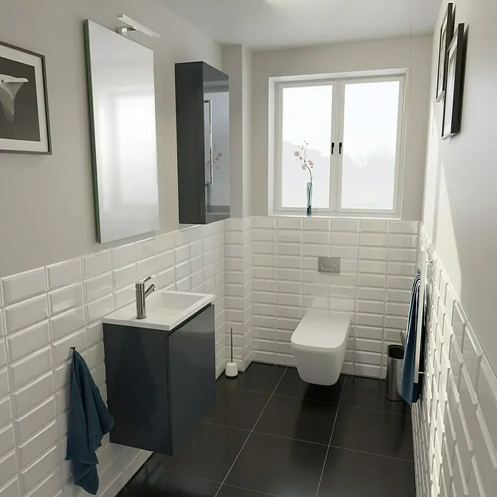 Camargue Espacio Badmöbel-Set H65 - 90 cm, Gama anthrazit glänzend - Ein Badezimmer mit schwarzen Fliesen und weißen Ziegelwänden. Das Waschbecken ist dunkelgrau und es gibt eine Toilette und einen Heizkörper.