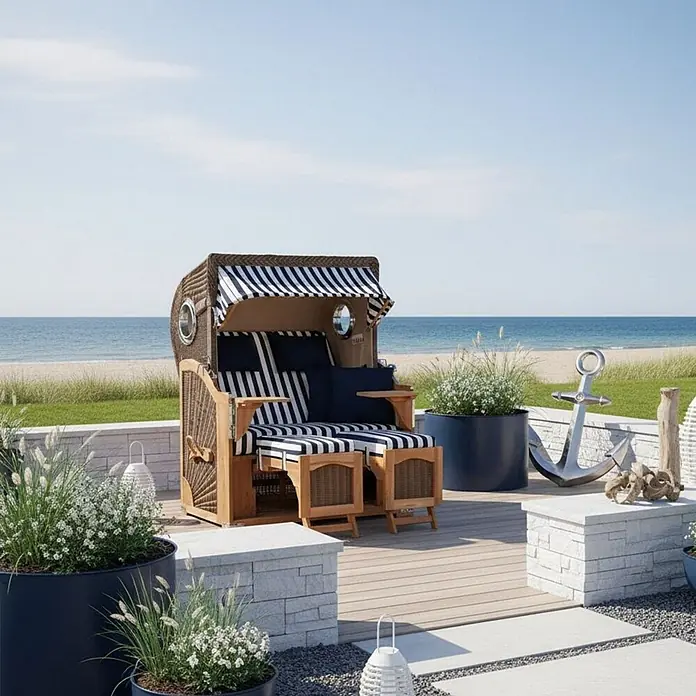 Mr. Deko Strandstuhl Strandkorb Düne Bullauge Teak PE Grey Dessin 518 - 1 Stk., Teakholz. Polyrattan, Rückenlehne verstellbar, PE Grey - Strandkorb aus Korbgeflecht und Holz mit marineblauen und weißen Streifen, auf einer Terrasse mit Blick auf einen Sandstrand und das Meer.