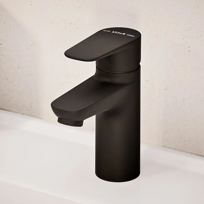 VitrA Flow Soft Waschtischarmatur - Schwarz, Höhe: 15 cm, Ohne Zugstange - Mattschwarze Vitra Armatur mit flachem Hebel auf weißem Waschbecken.