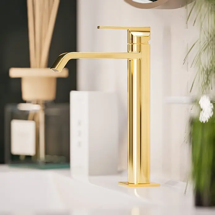 VitrA Suit Waschtischarmatur - Gold, Glänzend, Höhe: 26,4 cm - Ein hoher goldener moderner Wasserhahn steht auf einem weißen Waschbecken.