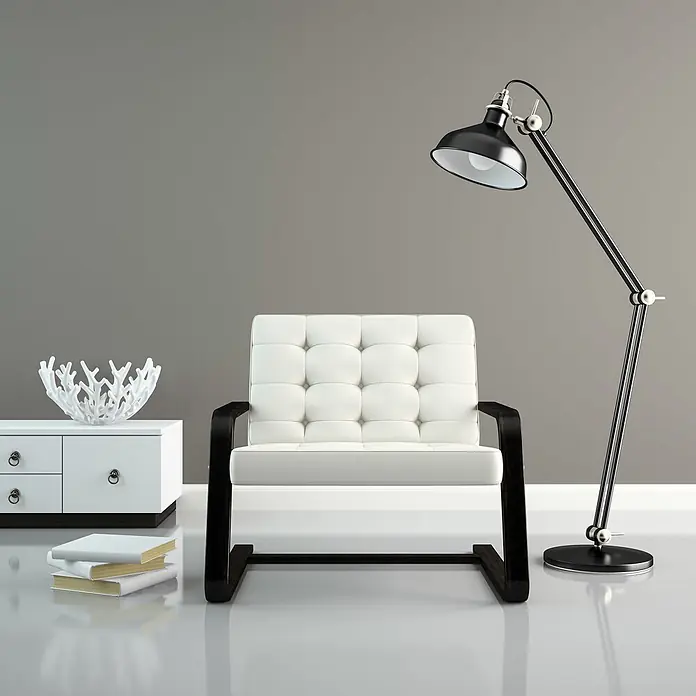 Livingwalls Wandfarbe Grau Creamy Grey DD125767 1l - Grau, Matt, 1 l - Moderne Wohnzimmerszene mit weißem Polstersessel, schwarzer Stehlampe und weißem Beistelltisch mit Büchern und Deko.