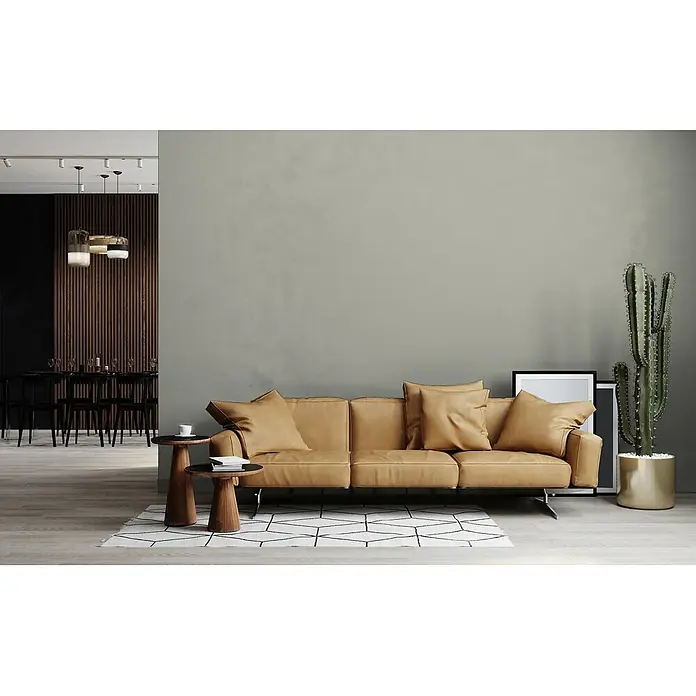 Livingwalls Wandfarbe Grau Calm Taupe DD126021 5l - Grau, Matt, 5 l - Ein modernes hellbraunes Ledersofa mit Kissen auf einem geometrischen Teppich, neben Holztischen in einem zeitgenössischen Wohnzimmer.