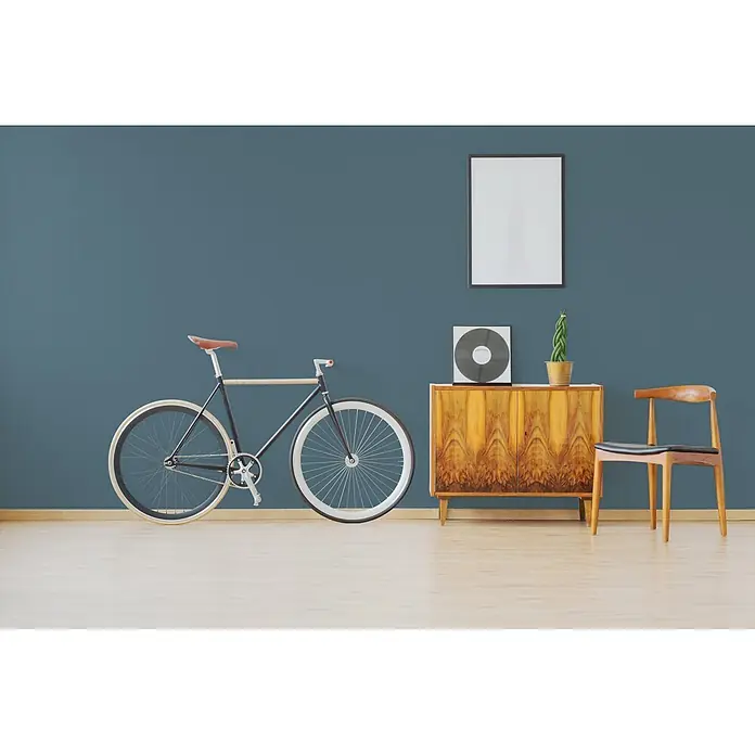 Livingwalls Wandfarbe Blau Blue Mussel 3011 5l - Matt, 5 l - Ein modernes Zimmer mit schwarzem Fahrrad, Vintage-Holzschrank und Stuhl, hellem Boden und blauer Wand.