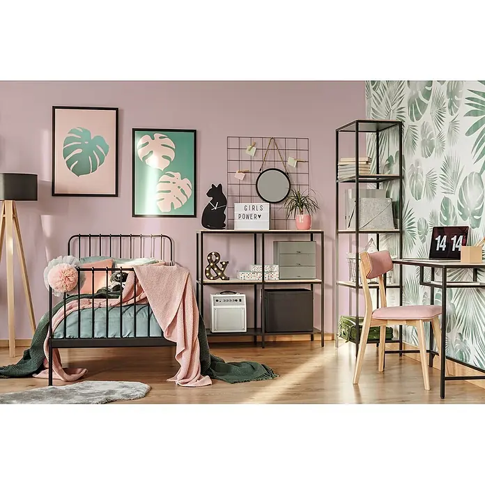 Livingwalls Wandfarbe Rosa Lovely Rose DD125793 5l - Rosa, Matt, 5 l - Schwarzes Metallbett mit rosafarbenen und grünen Textilien. Daneben steht ein schwarzes Metallregal mit Holzregalböden und integriertem Schreibtisch.