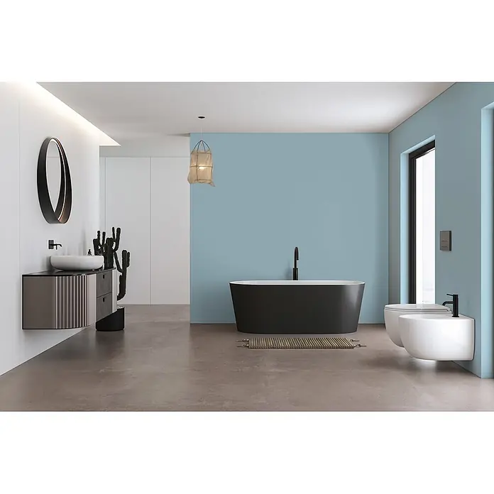 Livingwalls Wandfarbe Blau Ocean Blue DD125878 1l - Blau, Matt, 1 l - Modernes Bad mit schwarzer freistehender Wanne, Waschtisch mit weißem Waschbecken und wandhängendem WC und Bidet vor blauer Wand.