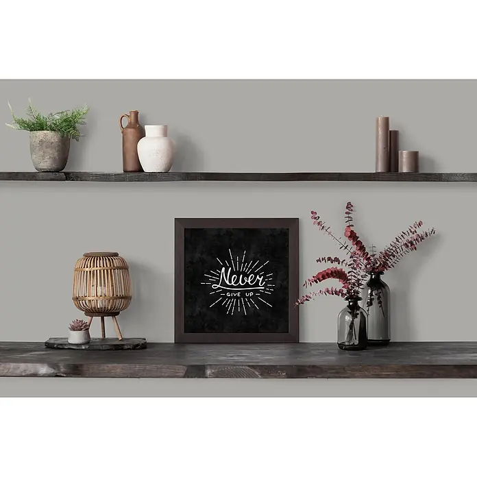 Livingwalls Wandfarbe Grau Grey Salt 1010 2,5l - Matt, 2,5 l - Dunkel gerahmtes 'Never Give Up' Bild, weißer Text auf Schwarz, auf einem Holzregal.