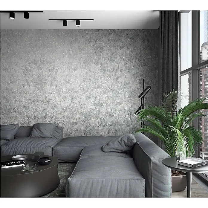 Livingwalls Vliestapete Betonoptik, grau silber - 10.050 x 530 mm - Modernes Wohnzimmer mit strukturierter grauer Wand, großem modularem Sofa und schwarzer Schienenbeleuchtung.
