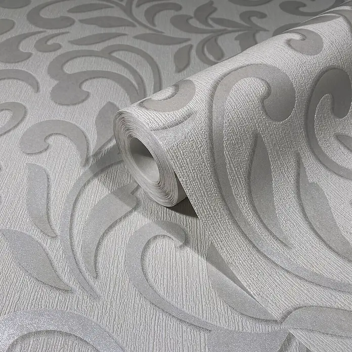 Livingwalls Vliestapete Grafisch, hellgrau, pearl - 10.050 x 530 mm - Teilweise abgerollte Rolle hellgrauer, texturierter Tapete mit geprägtem, dezentem floralem Schnörkelmuster.