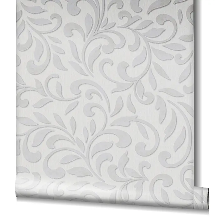 Livingwalls Vliestapete Grafisch, hellgrau, pearl - 10.050 x 530 mm - Weiße Tapete mit geprägtem grauem Blumen-/Damaschmuster, unten aufgerollt.