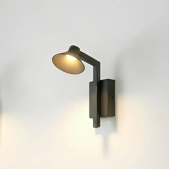 Lucande Wandleuchte Steve - schwarz, schwarz - Dunkle Metall-Wandlampe mit kantigem Arm und konischem Schirm, der warmes Licht abgibt.