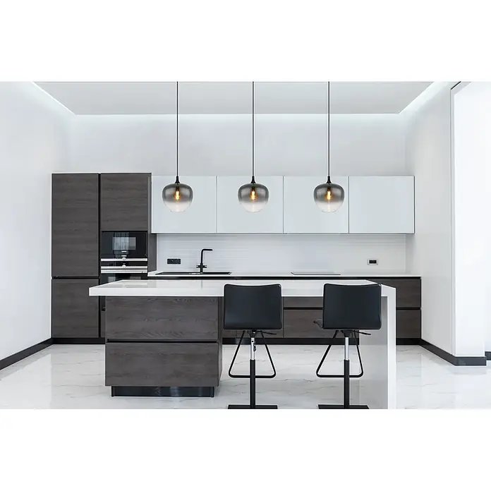 Globo Pendelleuchte Maxy - 60 W, Ø x H: 29 x 120 cm, 1-Strahlig, E27 - Drei rauchgraue Glaspendelleuchten mit schwarzen Kabeln hängen über einer weißen Kücheninsel.