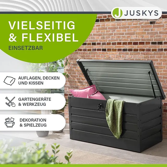 Juskys Garten-Aufbewahrungsbox Limani - L x B x H: 53 x 120 x 63 cm, grau, Metall - Dunkelgraue Metall-Gartenbox, halb geöffnet, mit Kissen und Decke. Vielseitig nutzbar für Auflagen, Gartengeräte oder Spielzeug.