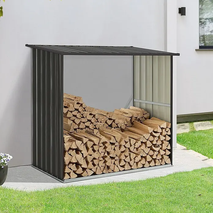 Juskys Kaminholzregal Enno - 163 x 163 x 154 cm, Metall, Grau - Dunkelgrauer Metall-Brennholzunterstand, gefüllt mit Holzscheiten.
