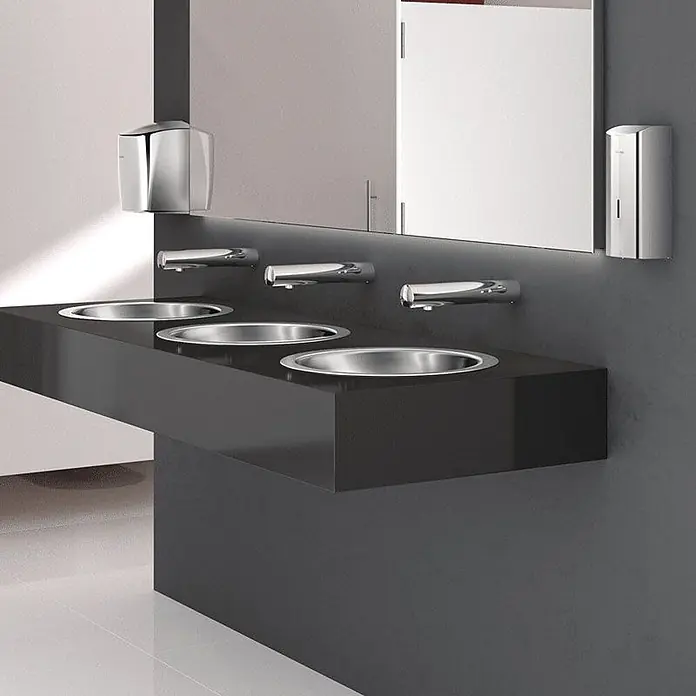 Delabie Waschtisch Delabie - Ohne Überlauf, Edelstahl - Moderne öffentliche Waschtheke mit drei Edelstahlbecken, Chrom-Wandarmaturen, automatischem Händetrockner und Seifenspender.