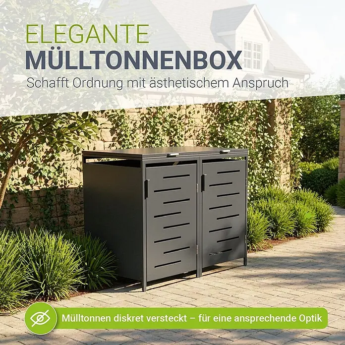Juskys Mülltonnenbox Arel - 136 x 80 cm, Metall, Anthrazit, Geeignet für Anzahl Mülltonnen: 2 Stk. - Dunkelgraue Metall-Mülltonnenbox mit zwei Fächern und Lamellentüren, auf einem gepflasterten Außenbereich mit Grünpflanzen.