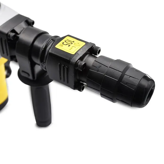 Bamato Abbruchhammer STH-155 - 1.300 W, 20 J, SDS-Max-Aufnahme - Nahaufnahme des schwarzen und gelben Bohrfuttermechanismus eines Abbruchhammers mit "LWA 105 dB" Etikett.