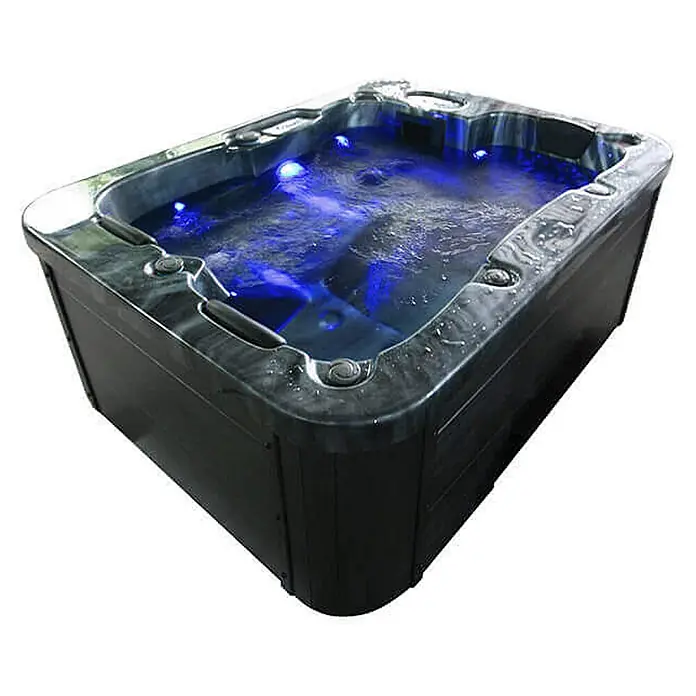 Home Deluxe Outdoor Whirlpool BLACK MARBLE Pure -  - Dunkelgrauer rechteckiger Whirlpool mit sprudelndem blau beleuchtetem Wasser.