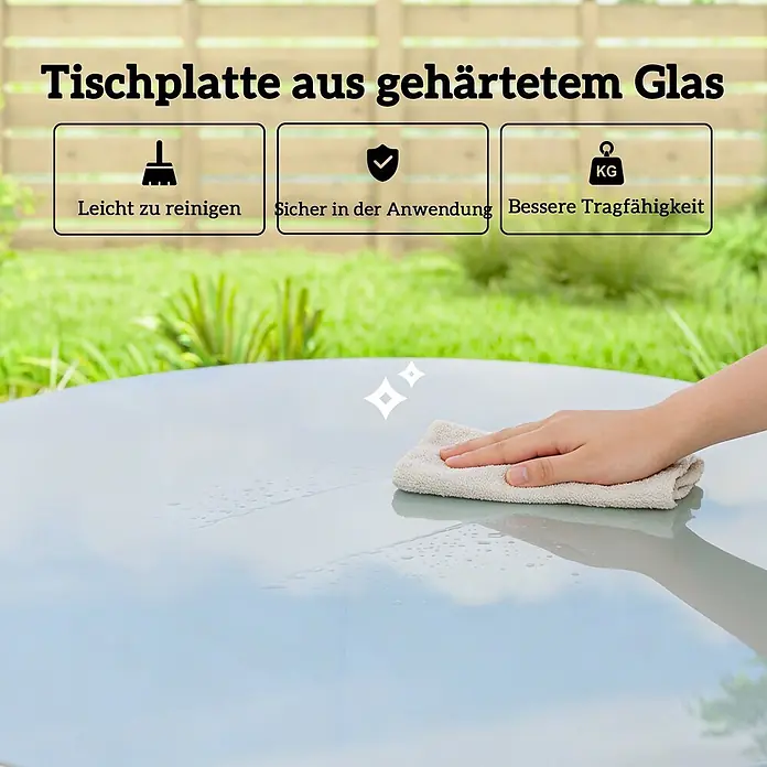 Outsunny Gartentisch rund - gehärtetes Glas, Grau - Hand reinigt eine runde Tischplatte aus gehärtetem Glas, was ihre Haltbarkeit und einfache Pflege hervorhebt.