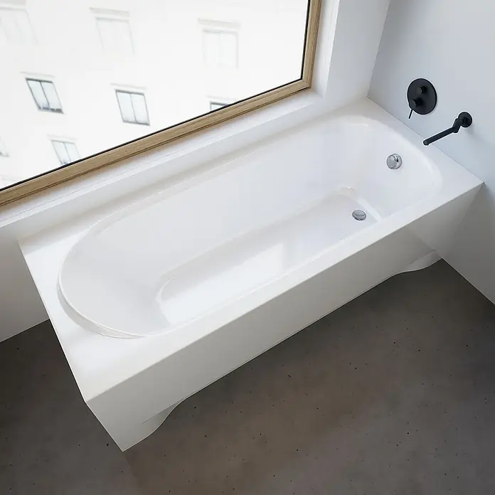 Bad Land Badewanne MEDIUM Acryl-Eckwanne 170 x 75 cm Weiß, inkl. Acrylschürze - Sanitäracryl, Weiß - Weiße rechteckige Badewanne mit abgerundetem Innenbereich, unter einem Fenster mit schwarzer Wandarmatur installiert.