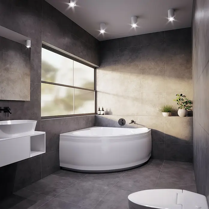 Bad Land Eckbadewanne MIA Acryl-Eckwanne 130 x 130 cm Weiß, inkl. Acrylschürze - Sanitäracryl, Weiß - Weiße Eckbadewanne in einem modernen grau gefliesten Badezimmer mit Waschtisch und großem Fenster.