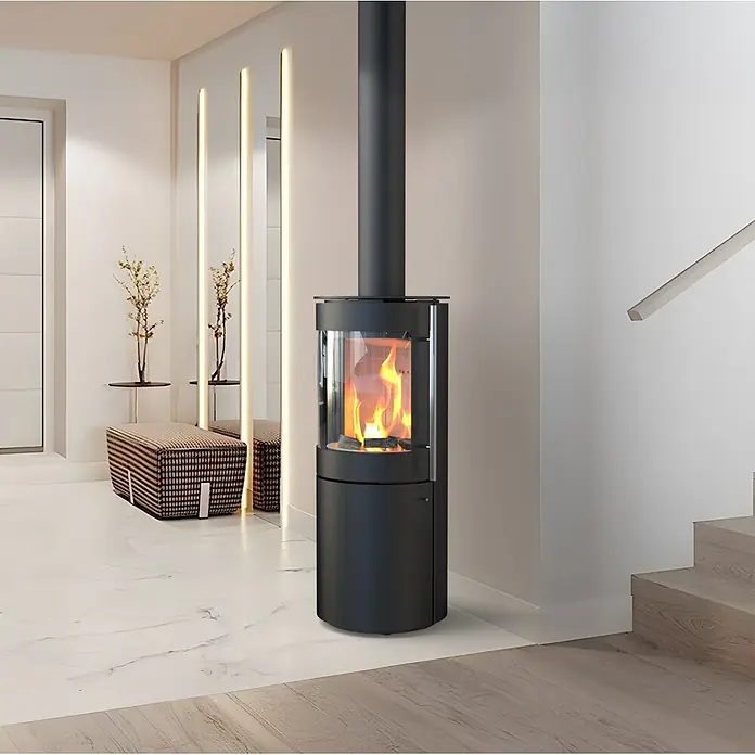 Kaminofen Xena Mini - 7 kW, Raumheizvermögen: 200 m³, Höhe: 115,5 cm - Moderner schwarzer Holzofen mit Glastür, aktiven Flammen, in einem zeitgenössischen Innenraum.