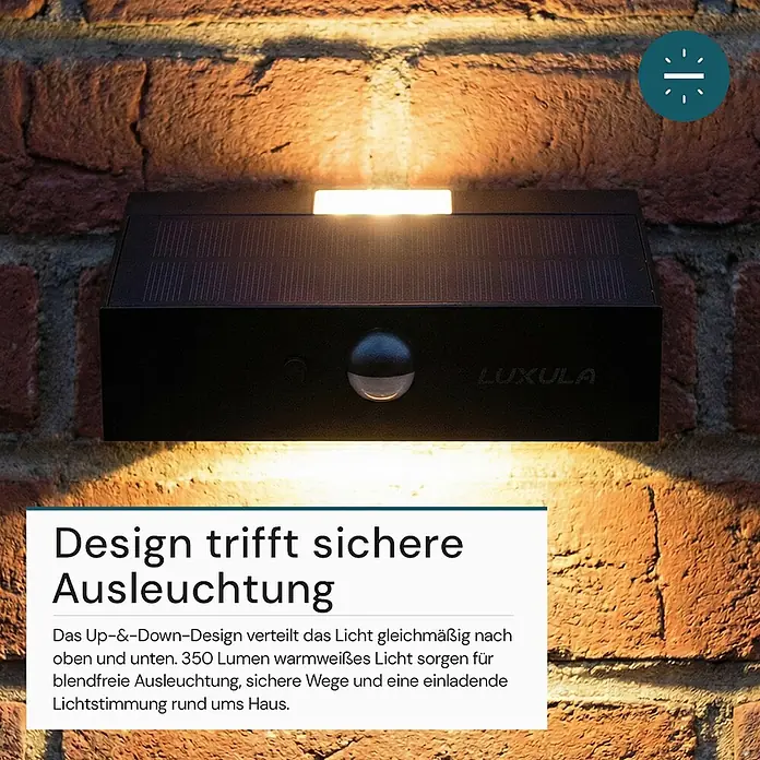 Luxula Solar-Außenwandleuchte - L x B x H: 13,7 x 3,5 x 9 cm, Schwarz, IP65, 350 lm - Schwarze Solar-Up-Down-Außenleuchte mit Bewegungsmelder an einer Ziegelwand, die warmweißes Licht nach oben und unten strahlt.