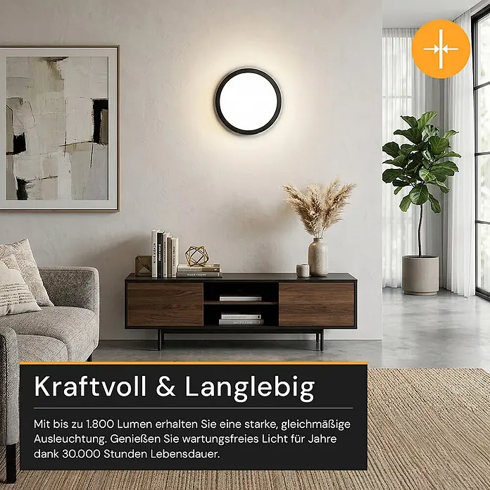 Enovalite LED-Deckenleuchte rund - 18 W, Ø x H: 21,5 x 1,95 cm, Schwarz, Schwarz, Mehrfarbig - Runde, schwarz gerahmte Wandleuchte an einer Wand, die einen modernen Wohnbereich beleuchtet.