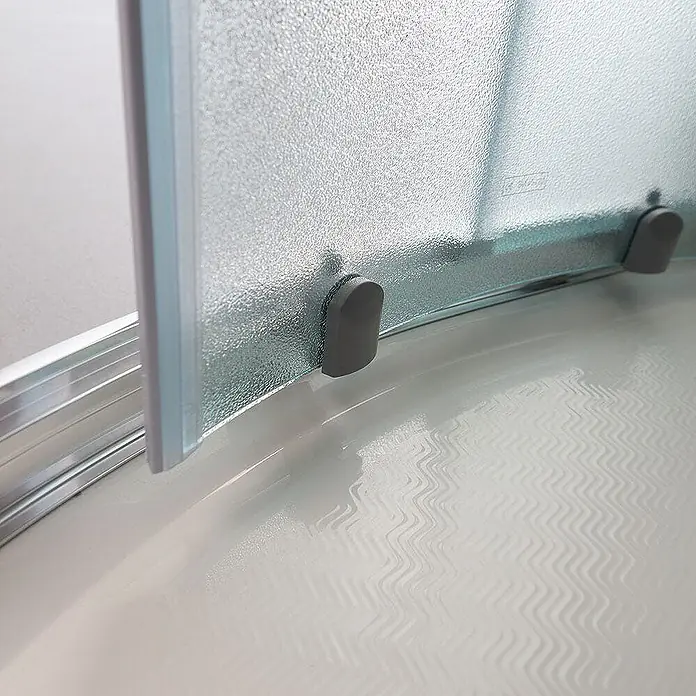 Kiamami Valentina Runddusche - 90 x 90 x 185 cm, Matt - Milchglas-Duschwand mit grauen Bodenstoppern und Metallschiene auf einer strukturierten Duschwanne.