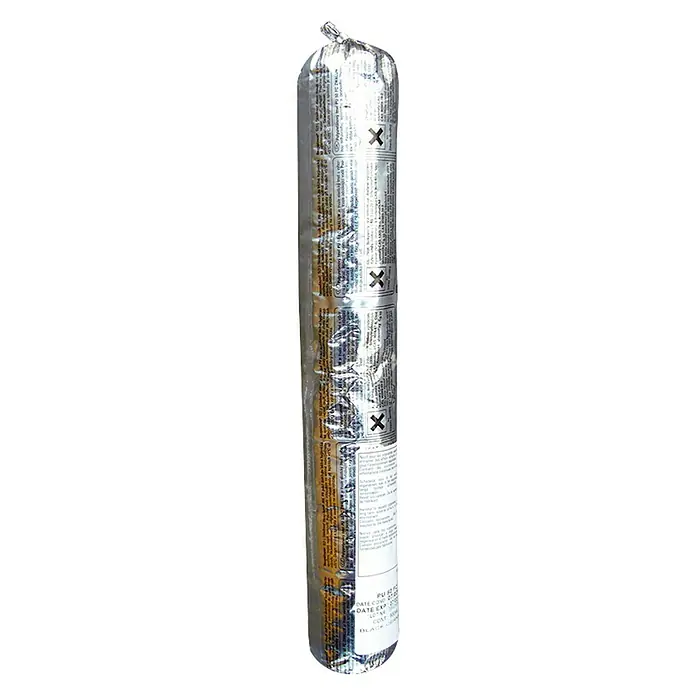 Schake Kleber - 600 ml, Geeignet für: Bodenschwellen - Eine lange, silberne Kartusche Dichtmasse, verpackt in Folie mit aufgedruckten Informationen und schwarzen "X"-Markierungen.