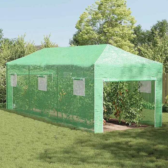 Furnicato Gewächshaus - Außenmaß inkl. Dachüberstand (B x T): 870 x 290 cm, Material Seitenwand: Kunststoff, 38 mm, Grün - Grünes Maschengewächshaus im Garten, mit aufrollbaren Fenstern und Pflanzen darin.