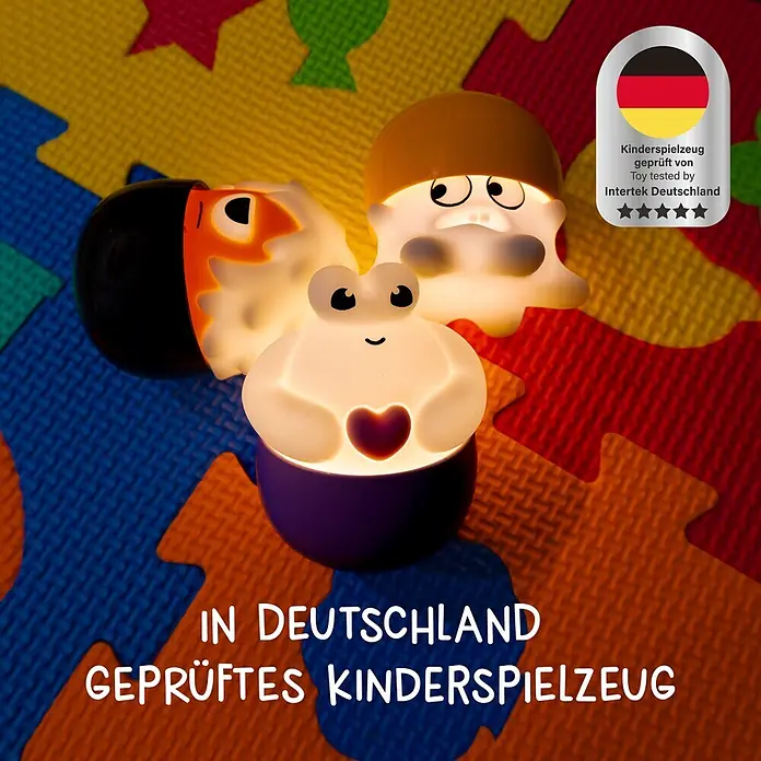 MegaLight LED-Nachtlicht Mystery Lights Eggys Monster - 0,2 W, L x B x H: 70 x 65 x 65 mm, RGBW, 1 Stk. - Drei leuchtende Kinder-Nachtlichter, ein Frosch, ein Geist und ein Vogel, auf einer bunten Schaumstoffmatte.