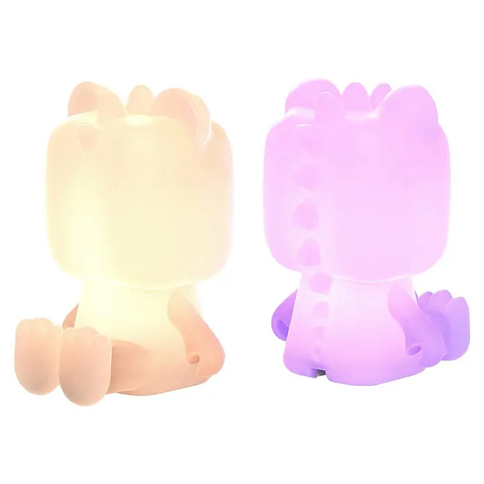Mob Lámpara de sobremesa LED Cute Animal Dinosaurio - 1 W, L x An x Al: 10 x 8 x 14 cm, Blanco, Dinosaurio - Dos figuras translúcidas luminosas, una crema y una púrpura, con forma de animales sentados, probablemente luces nocturnas.