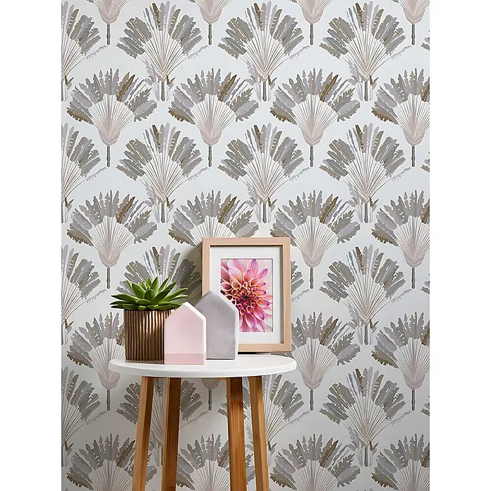 Profhome Vliestapete Vliestapete Palmen grau - braun, 10.050 x 530 mm - Tapete mit sich wiederholendem Muster aus stilisierten Fächerpalmenblättern in Beige, Grau und Braun, an einer Wand mit kleinem Tisch.