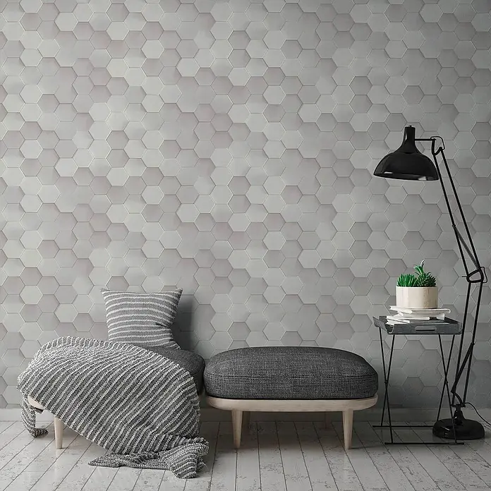 Profhome Vliestapete Heißgeprägte Vliestapete Kachelmuster grau - 10.050 x 530 mm - Strukturierte hellgraue sechseckige Wandfliesen bilden ein modernes geometrisches Muster in einem Wohnraum.