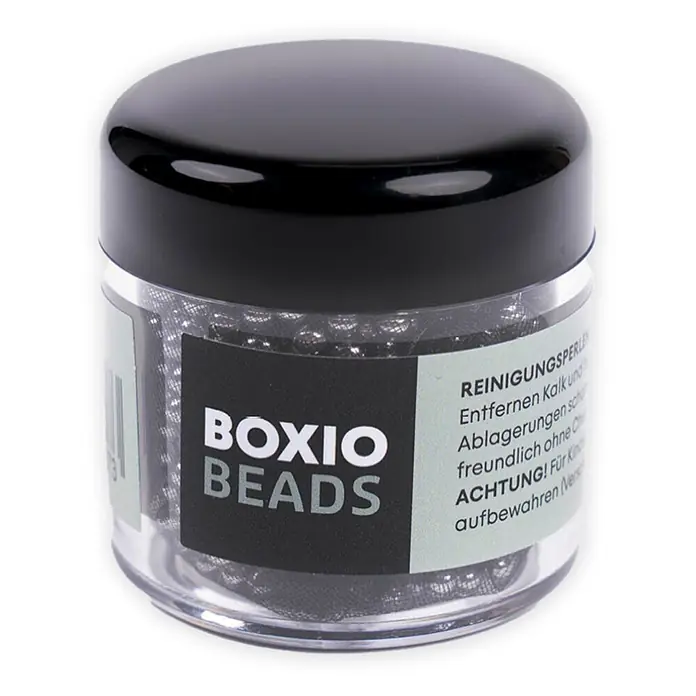 Boxio Reinigungsperlen Beads - Edelstahl - Transparentes Glas mit schwarzem Deckel, gefüllt mit silbernen BOXIO BEADS Reinigungskugeln.