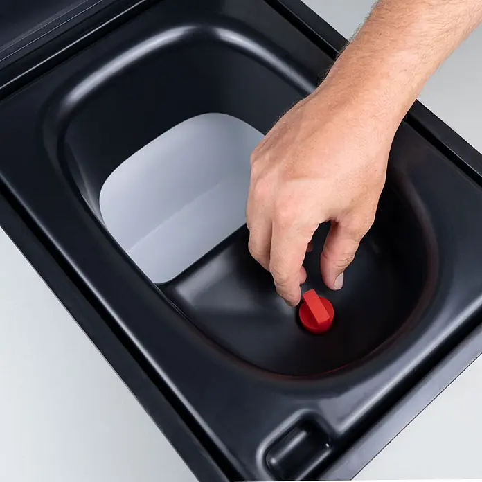 Boxio Verschlussstopfen Plug - Passend für: Boxio Campingtoilette - Hand dreht roten Knopf in schwarzem, eingelassenem WC/Becken.