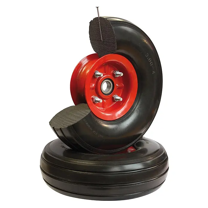 Variofit Sackkarre Stahlrohrkarren 250kg Traglast mit Kunststoffgleitkufen pannensicheres Rad - Traglast: 250 kg - Rotes Metallrad mit schwarzem, pannensicherem Reifen im Querschnitt, der einen Nagel ohne Plattfuß zeigt.