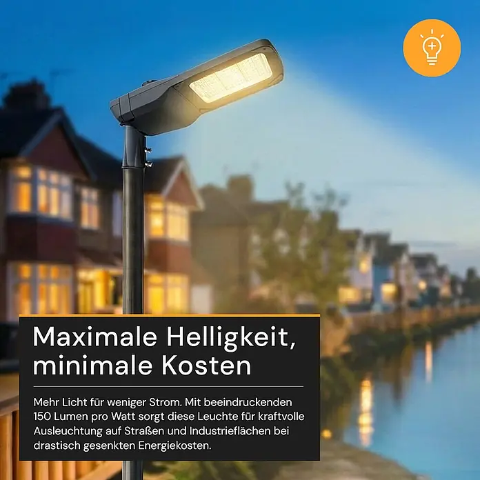 Enovalite LED-Strahler -  - Eine moderne dunkelsgraue LED-Straßenlaterne, die eine Wohnstraße bei Nacht hell erleuchtet.