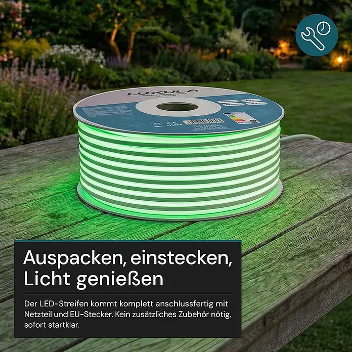 Luxula LED-Lichtschlauch - Länge: 5.000 cm - Leuchtend grüner LED-Streifen auf einer Rolle auf einem Holztisch im Garten.