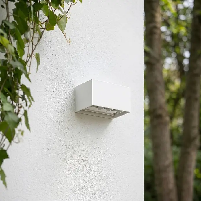 Lindby Außenwandleuchte Nivar - weiß / opal, weiß / opal, IP54 - Weiße rechteckige Außenwandleuchte an strukturierter Wand, mit nach unten gerichteten Lichtöffnungen.
